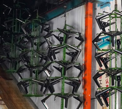 Metal sofa legs undergoing spray painting, highlighting DELTA CAINA's advanced surface treatment processes for durable and visually appealing furniture hardware